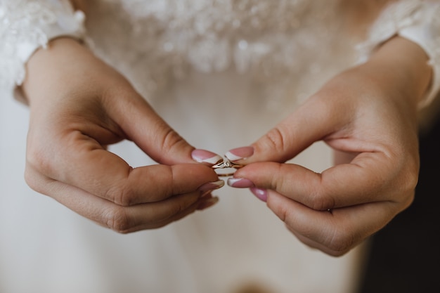 Tender engagement ring in the bride's hands