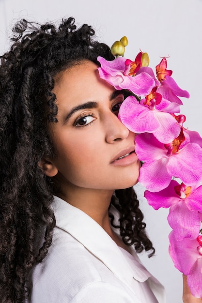 Free photo tender  ethnic woman with tropical flower