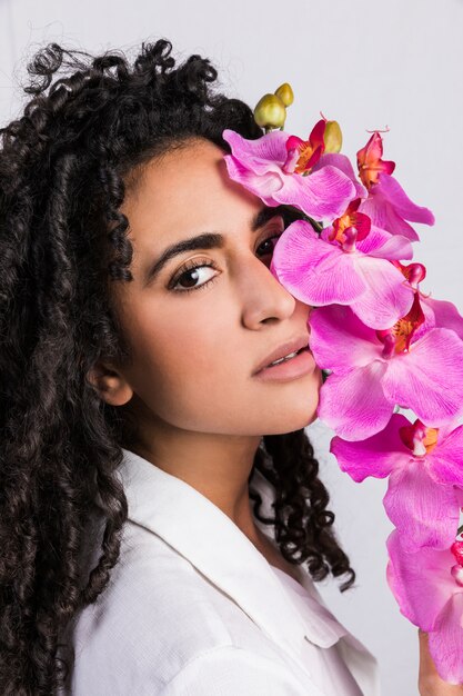 Tender  ethnic woman with tropical flower 