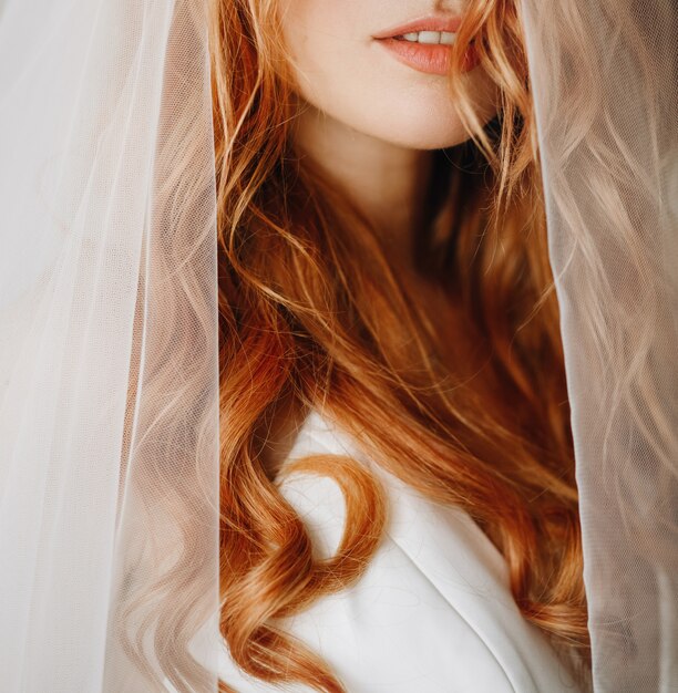 Tender lips and skin of charming bride with red curly hair