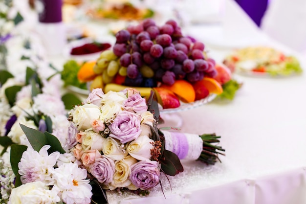 Tender wedding bouquet made of beige and violet roses