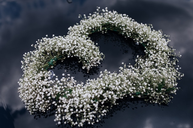 Tender wreath of gypsophila on the car windscreen