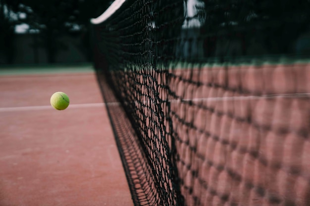 Tennis ball reaching net