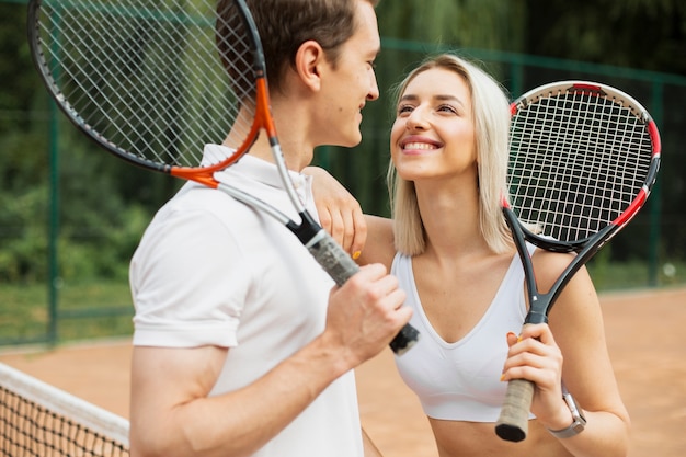 Tennis couple smiling at each other