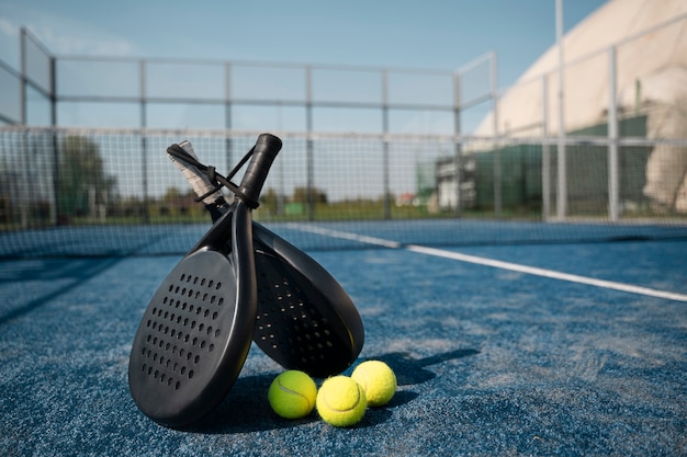 Free photo tennis paddles and balls arrangement