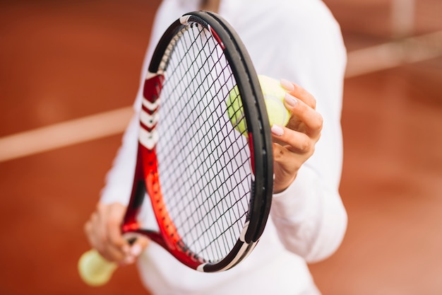 Tennis player holding tennis equipment