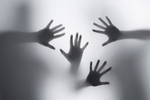 Free photo terrifying hands silhouettes in studio