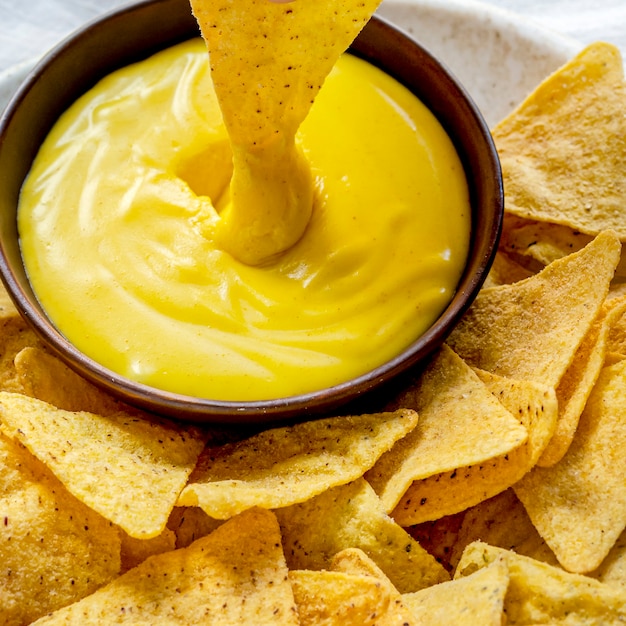 Free photo tex mex corn tortilla chips with cheddar cheese dip