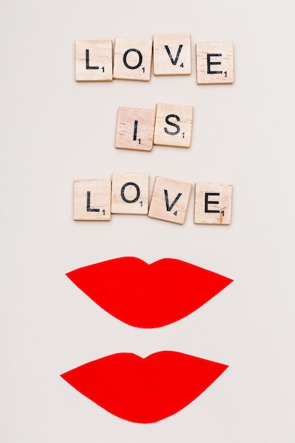 Free photo text love is love and red lips