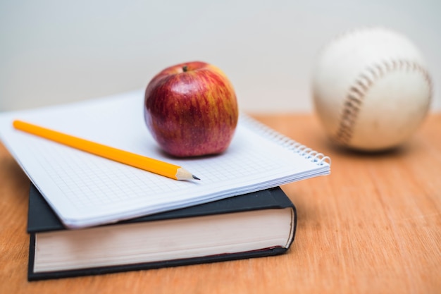 Textbook and notebook with apple