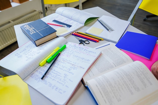 Textbooks and notepads on table