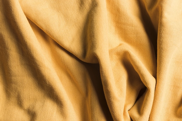 Texture of sand brown crumpled fabric