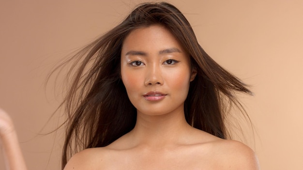 Free photo thai asian japanese model closeup portrait with hair blowing out simmetrical portrait