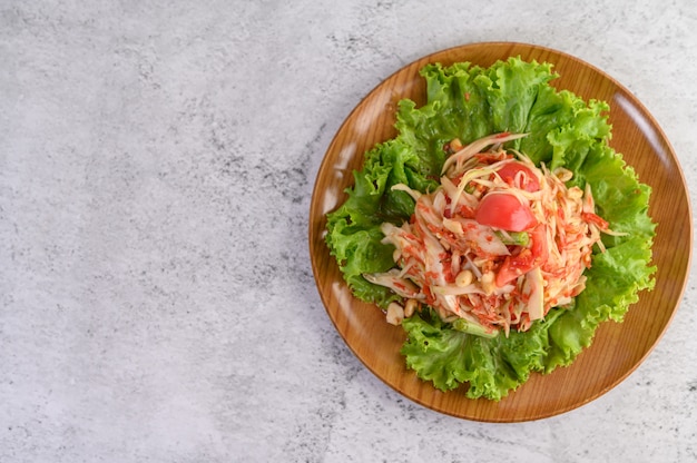 Free Photo thai papaya salad on a wooden plate