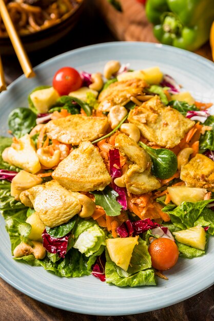 Thai salad with chicken and vegetables on ceramic plate