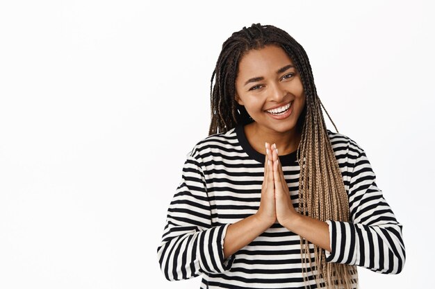 Thank you Smiling black woman bowing with namaste gratitude hands gesture thanking standing over white background