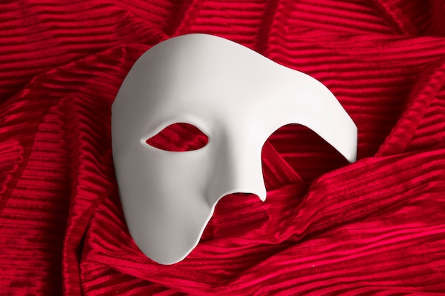 Free photo theater mask on red curtain