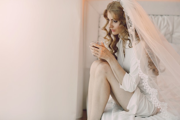 Free photo thinking bride with a cup