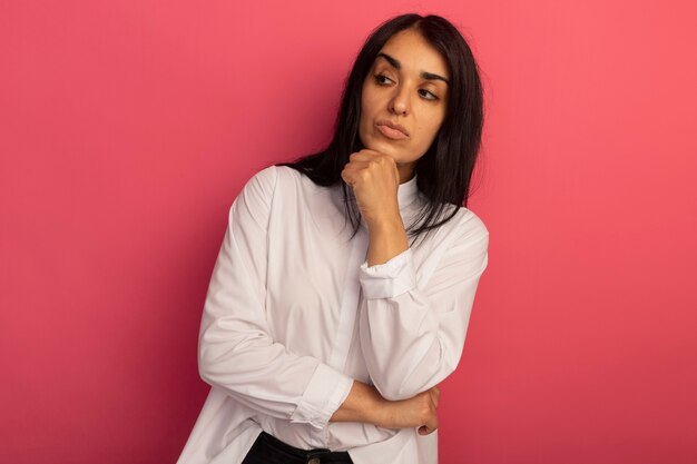 Thinking looking at side young beautiful woman wearing white t-shirt grabbed chin