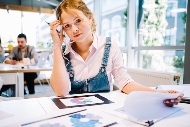 Free Photo thinking woman with papers