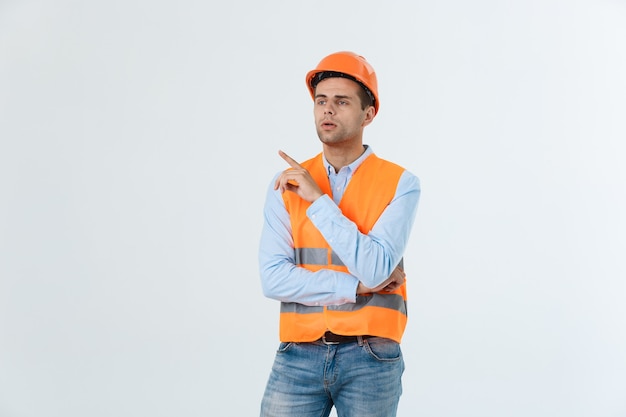 Thoughtful architect or engineer serious thinking against grey background.