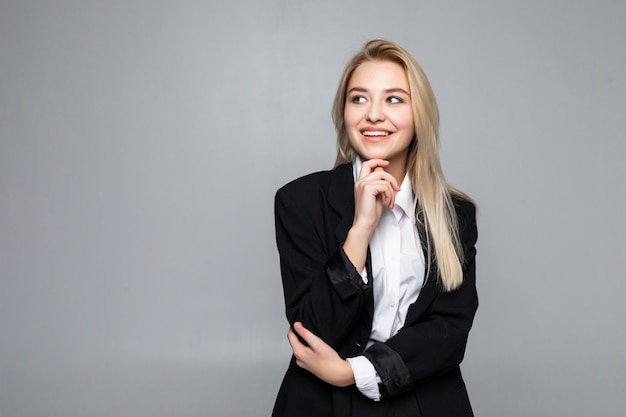 Thoughtful businesswoman with a finger under chin looking isolated.