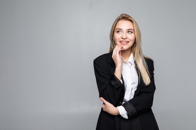 Thoughtful businesswoman with a finger under chin looking isolated.