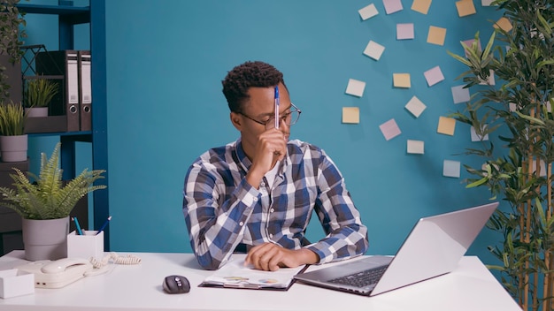 Thoughtful employee brainstorming ideas to plan business strategy, contemplation concept. Pensive worker thinking about successful solution, using creative imagination for growth.