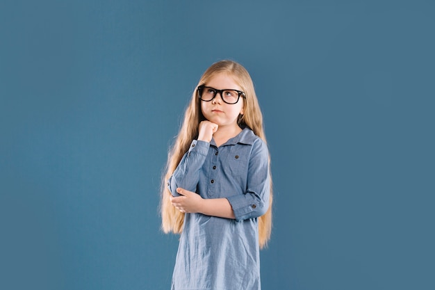 Thoughtful girl in glasses