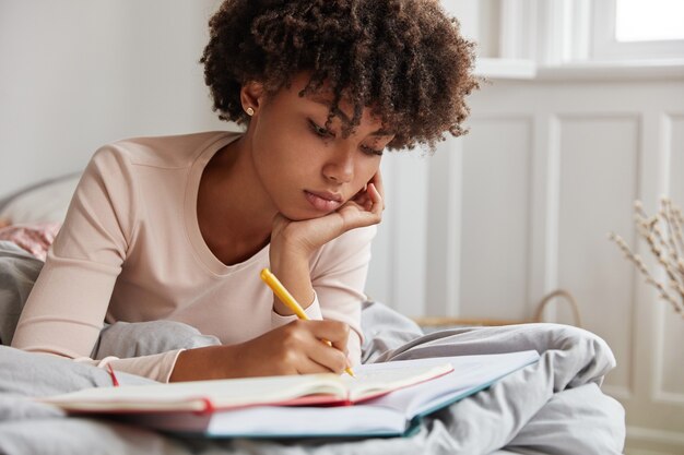 thoughtful girl posing at home in comfortable bed