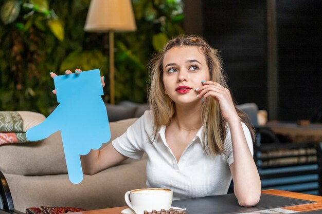 Thoughtful lady holding idea box and looking aisde