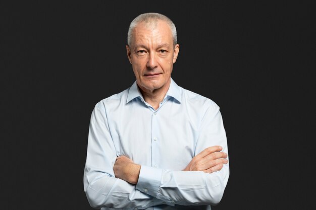 Thoughtful senior man in a light blue shirt