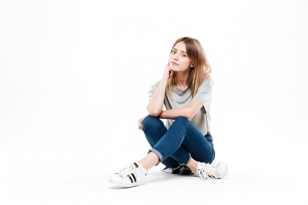 Thoughtful woman sitting cross-legged