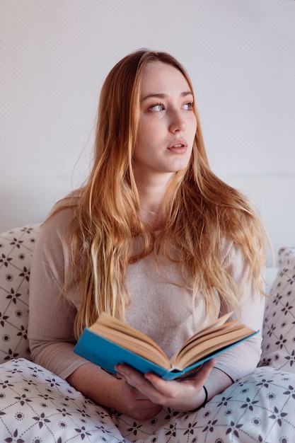 Thoughtful woman with book