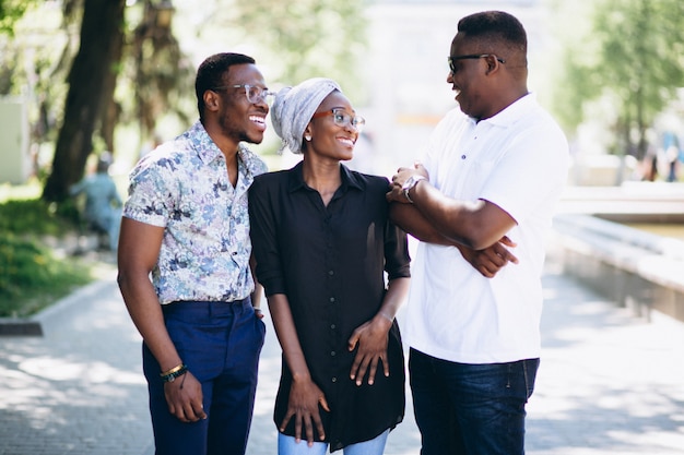 Three afican american people talking in the street