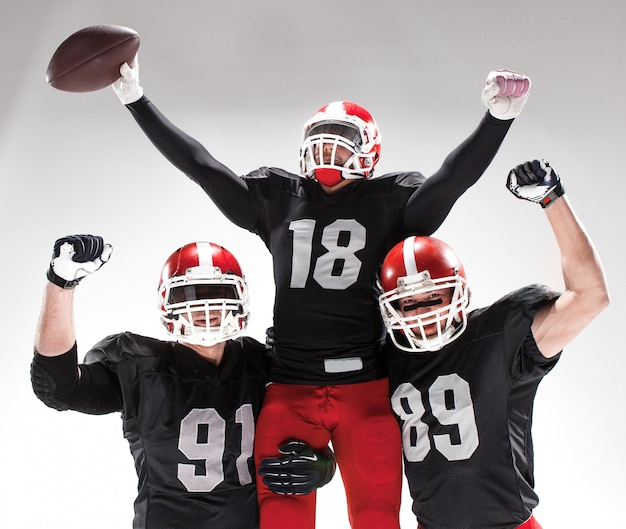 Free photo the three american football players posing