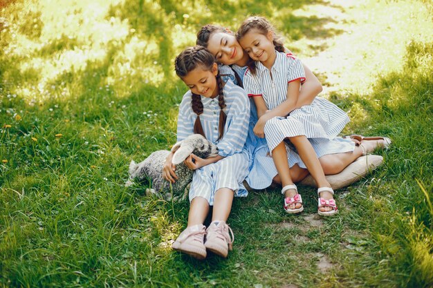 three beautiful and cute girls in blue dresses with beautiful hairstyles and make-up sitting