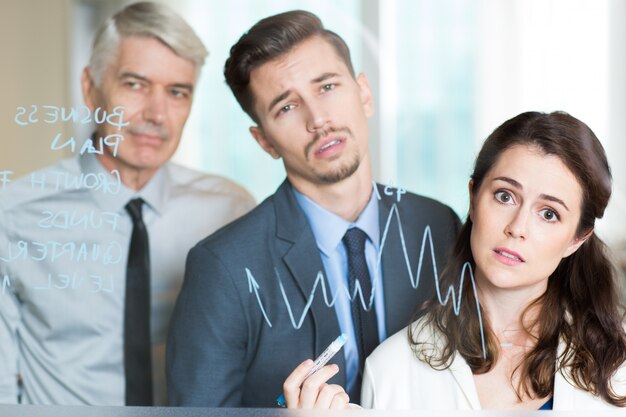 Three Bored Business People Analyzing Graph