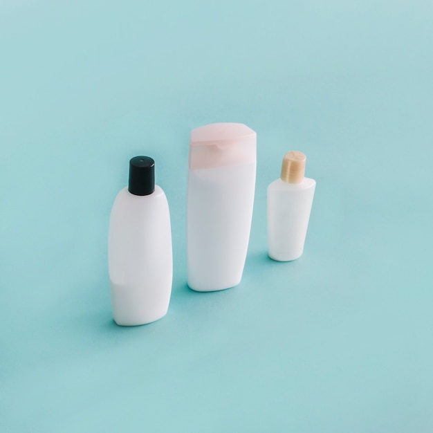 Free Photo three bottles with smooth cosmetics