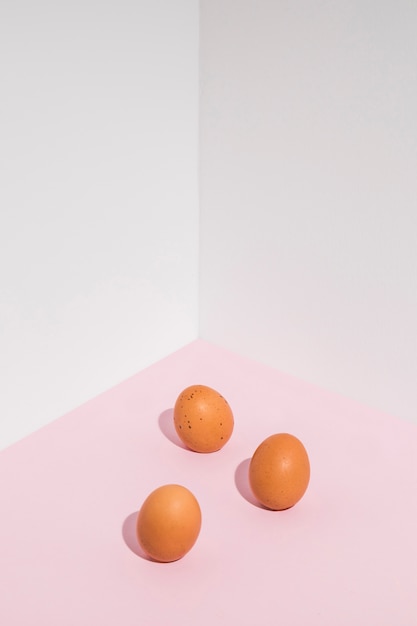 Three brown chicken eggs on table