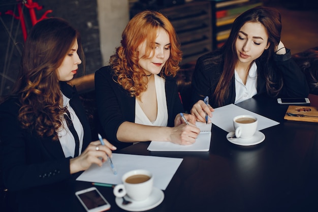 three businesswomen in a cafe