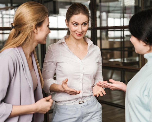 Three businesswomen discussing indoors