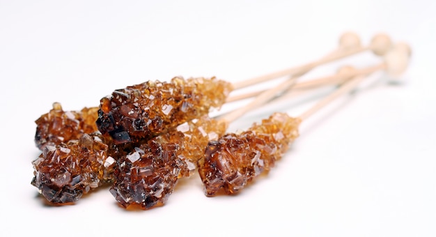 Three candy sugar on a stick over white background