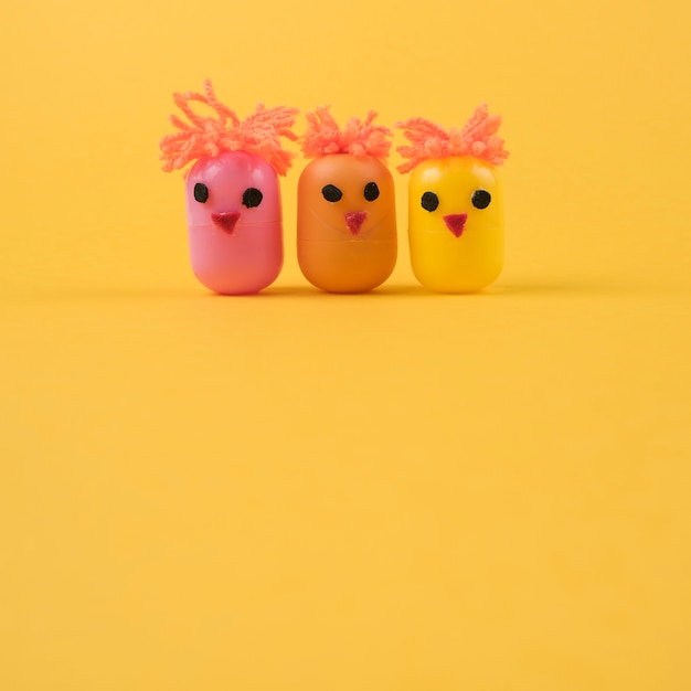 Free photo three chickens made of egg toy boxes