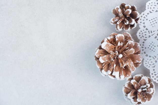 Three Christmas pinecones on white background. High quality photo