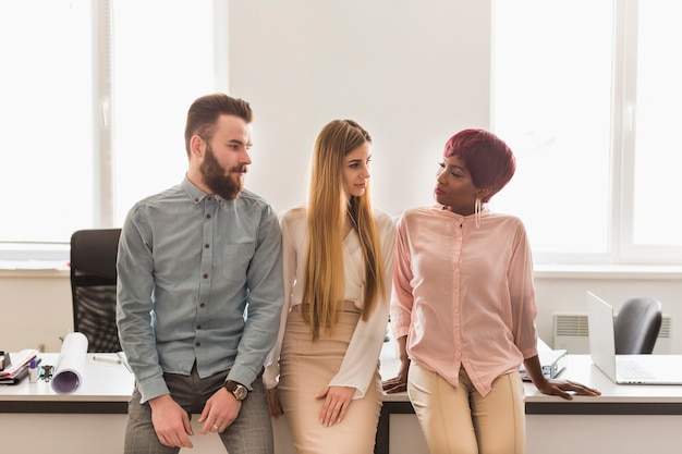 Three colleagues near table