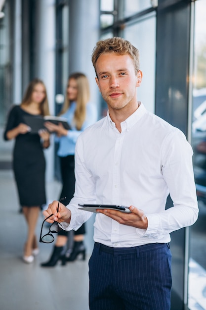 Three collegues working at a car showroom