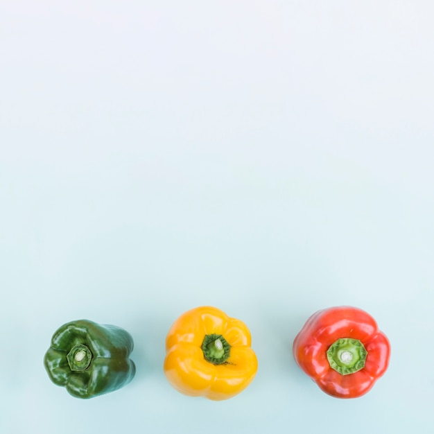 Free photo three colorful bell peppers from above