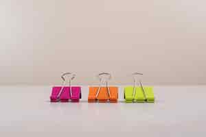 Free photo three colorful paper clips on white background