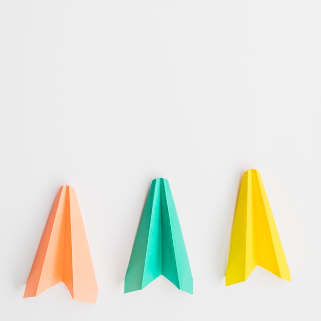 Three colorful paper planes in row